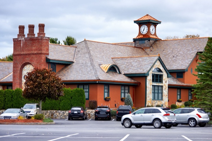 Commercial building remodeled by NW Build, with a brick and shingle façade and a clock tower entrance.